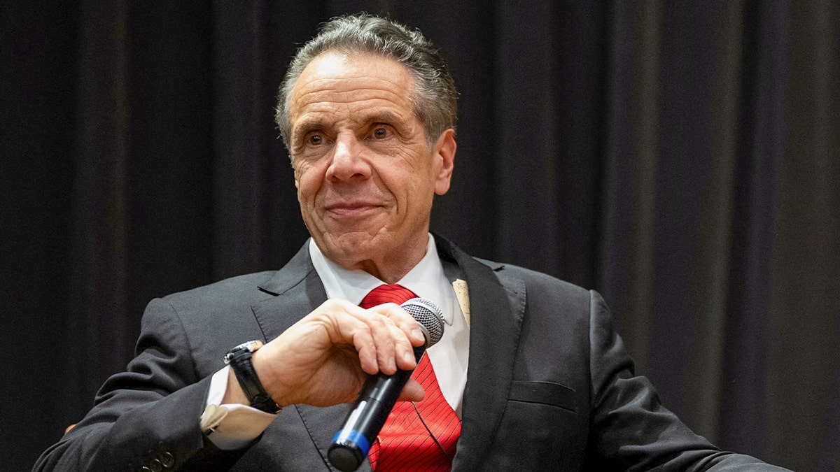 Cuomo closeup shot, holding microphone