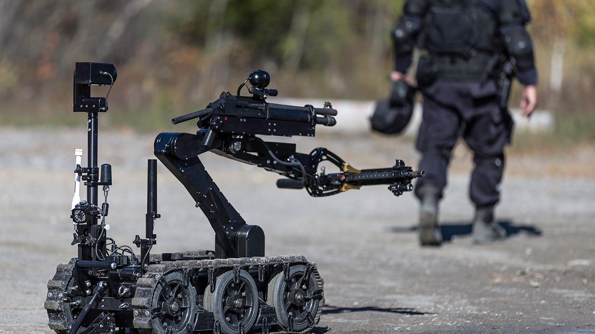 Police Swat Officer Using a Mechanical Arm Bomb Disposal Robot Unit