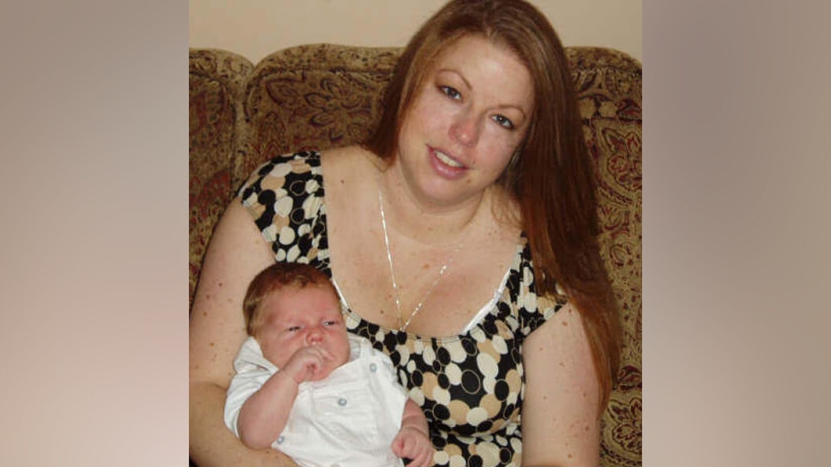 Raelyn Balfour holds her late son, Bryce Balfour